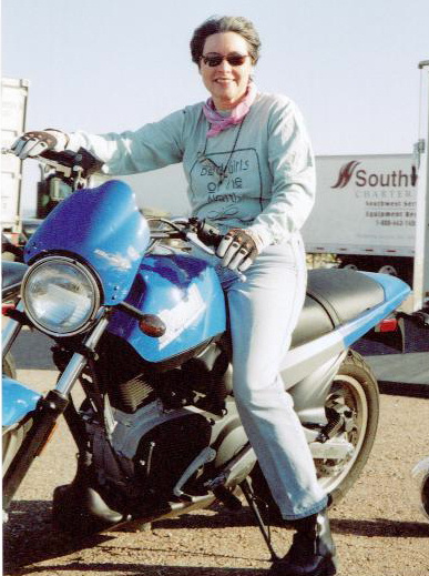 Judi learning to ride a motorcycle while researching The Laws of Harmony.